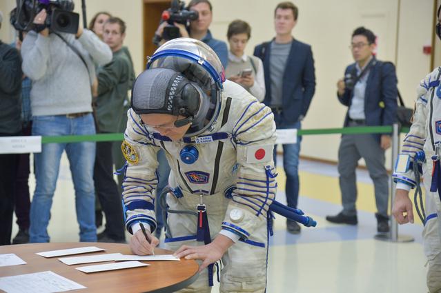 NASA image: jsc2017e135202 - At the Gagarin Cosmonaut Training Center in Star City, Russia, Expedition 54-55 prime crewmember Norishige Kanai of the Japan Aerospace Exploration Agency (JAXA) signs in for the start of the crew’s final qualification exam activities N