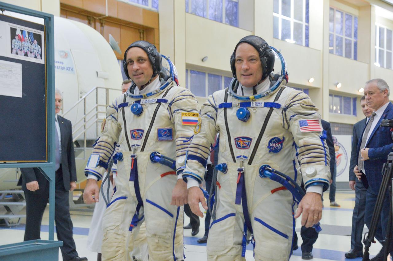 jsc2017e135203 - At the Gagarin Cosmonaut Training Center in Star City, Russia, Expedition 54-55 prime crewmembers Anton Shkaplerov of the Russian Federal Space Agency (Roscosmos, left) and Scott Tingle of NASA (right) walk through a Soyuz spacecraft simulator building Nov. 29 as part of their final crew qualification exam activities. They will launch with Norishige Kanai of the Japan Aerospace Exploration Agency (JAXA) Dec. 17 on the Soyuz MS-07 spacecraft from the Baikonur Cosmodrome in Kazakhstan for a five-month mission on the International Space Station...NASA/Elizabeth Weissinger.