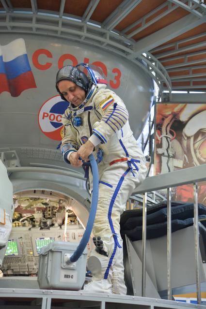 NASA image: jsc2017e135211 - At the Gagarin Cosmonaut Training Center in Star City, Russia, Expedition 54-55 prime crewmember Anton Shkaplerov of the Russian Federal Space Agency (Roscosmos) disconnects a cooling system hose as he boards a Soyuz spacecraft simulator 