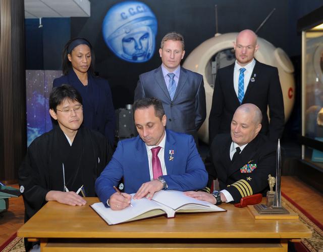 jsc2017e136047 - At the Gagarin Cosmonaut Training Center in Star City, Russia, Expedition 54-55 prime crewmember Anton Shkaplerov of the Russian Federal Space Agency (Roscosmos) signs a ceremonial book Nov. 30 as part of traditional pre-launch ceremonies. In the front row from left to right are the prime crewmembers, Norishige Kanai of the Japan Aerospace Exploration Agency (JAXA), Shkaplerov and Scott Tingle of NASA. Looking on in the back row are the backup crewmembers, NASA’s Jeanette Epps, Sergey Prokopyev of Roscosmos and Alexander Gerst of the European Space Agency. Shkaplerov, Tingle and Kanai will launch Dec. 17 on the Soyuz MS-07 spacecraft from the Baikonur Cosmodrome in Kazakhstan for a five-month mission on the International Space Station...Andrey Shelepin/Gagarin Cosmonaut Training Center.