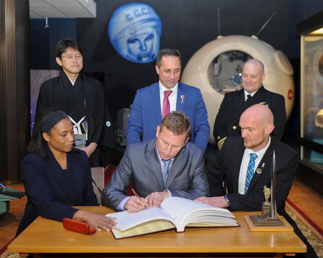 jsc2017e136050 - At the Gagarin Cosmonaut Training Center in Star City, Russia, Expedition 54-55 backup crewmember Sergey Prokopyev of the Russian Federal Space Agency (Roscosmos) signs a ceremonial book Nov. 30 as part of traditional pre-launch ceremonies. In the front row from left to right are the backup crewmembers, NASA’s Jeanette Epps, Prokopyev and Alexander Gerst of the European Space Agency. In the back row are the prime crewmembers, Norishige Kanai of the Japan Aerospace Exploration Agency (JAXA), Anton Shkaplerov of Roscosmos and Scott Tingle of NASA. Shkaplerov, Tingle and Kanai will launch Dec. 17 on the Soyuz MS-07 spacecraft from the Baikonur Cosmodrome in Kazakhstan for a five-month mission on the International Space Station...Andrey Shelepin/Gagarin Cosmonaut Training Center.