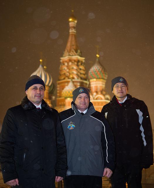 jsc2017e136059 - On a snowy night at Red Square in Moscow, Expedition 54-55 crewmembers Anton Shkaplerov of the Russian Federal Space Agency (Roscosmos, left), Scott Tingle of NASA (center) and Norishige Kanai of the Japan Aerospace Exploration Agency (JAXA, right) pose for pictures in front of St. Basil’s Cathedral in traditional pre-launch ceremonies Nov. 30. They will launch from the Baikonur Cosmodrome in Kazakhstan on the Soyuz MS-07 spacecraft Dec. 17 for a five-month mission on the International Space Station...Andrey Shelepin/Gagarin Cosmonaut Training Center.