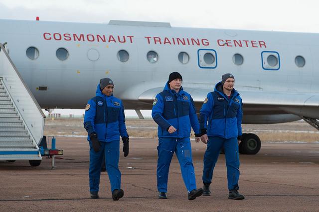 jsc2017e136096 - Expedition 54-55 backup crewmembers Jeanette Epps of NASA (left), Sergey Prokopyev of the Russian Federal Space Agency (Roscosmos, center) and Alexander Gerst of the European Space Agency (right) arrive at the launch site at the Baikonur Cosmodrome in Kazakhstan Dec. 4 following a flight from their training base in Star City, Russia. They are serving as backups to the prime crew, Scott Tingle of NASA, Anton Shkaplerov of the Russian Federal Space Agency (Roscosmos) and Norishige Kanai of the Japan Aerospace Exploration Agency (JAXA), who will launch Dec. 17 on the Soyuz MS-07 spacecraft for a five-month mission on the International Space Station...Andrey Shelepin/Gagarin Cosmonaut Training Center.