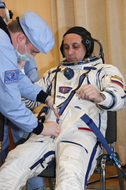 jsc2017e136447 - In the Integration Facility at the Baikonur Cosmodrome in Kazakhstan, Expedition 54-55 crewmember Anton Shkaplerov of the Russian Federal Space Agency (Roscosmos) suits up Dec. 5 for the first fit check dress rehearsal activity in the Soyuz MS-07 spacecraft. Shkaplerov, Scott Tingle of NASA and Norishige Kanai of the Japan Aerospace Exploration Agency (JAXA), will launch Dec. 17 in the Soyuz MS-07 vehicle for a five-month mission on the International Space Station...Courtesy of Roscosmos.