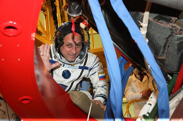 jsc2017e136449 - In the Integration Facility at the Baikonur Cosmodrome in Kazakhstan, Expedition 54-55 crewmember Anton Shkaplerov waves as he boards the Soyuz MS-07 spacecraft as part of the first fit check dress rehearsal activities. Shkaplerov, Norishige Kanai of the Japan Aerospace Exploration Agency (JAXA) and Scott Tingle of NASA (right) will launch Dec. 17 in the Soyuz MS-07 vehicle for a five-month mission on the International Space Station...Courtesy of Roscosmos.