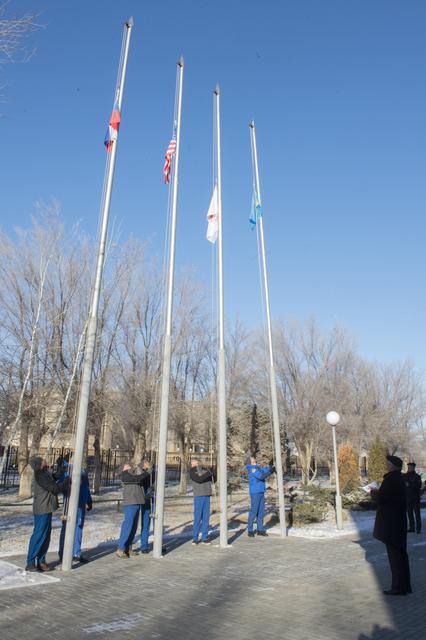 jsc2017e136940 - At the Cosmonaut Hotel crew quarters in Baikonur, Kazakhstan, the Expedition 54-55 prime and backup crewmembers raise the flags of Russia, the United States, Japan and Kazakhstan Dec. 6 in traditional pre-launch ceremonies. Anton Shkaplero