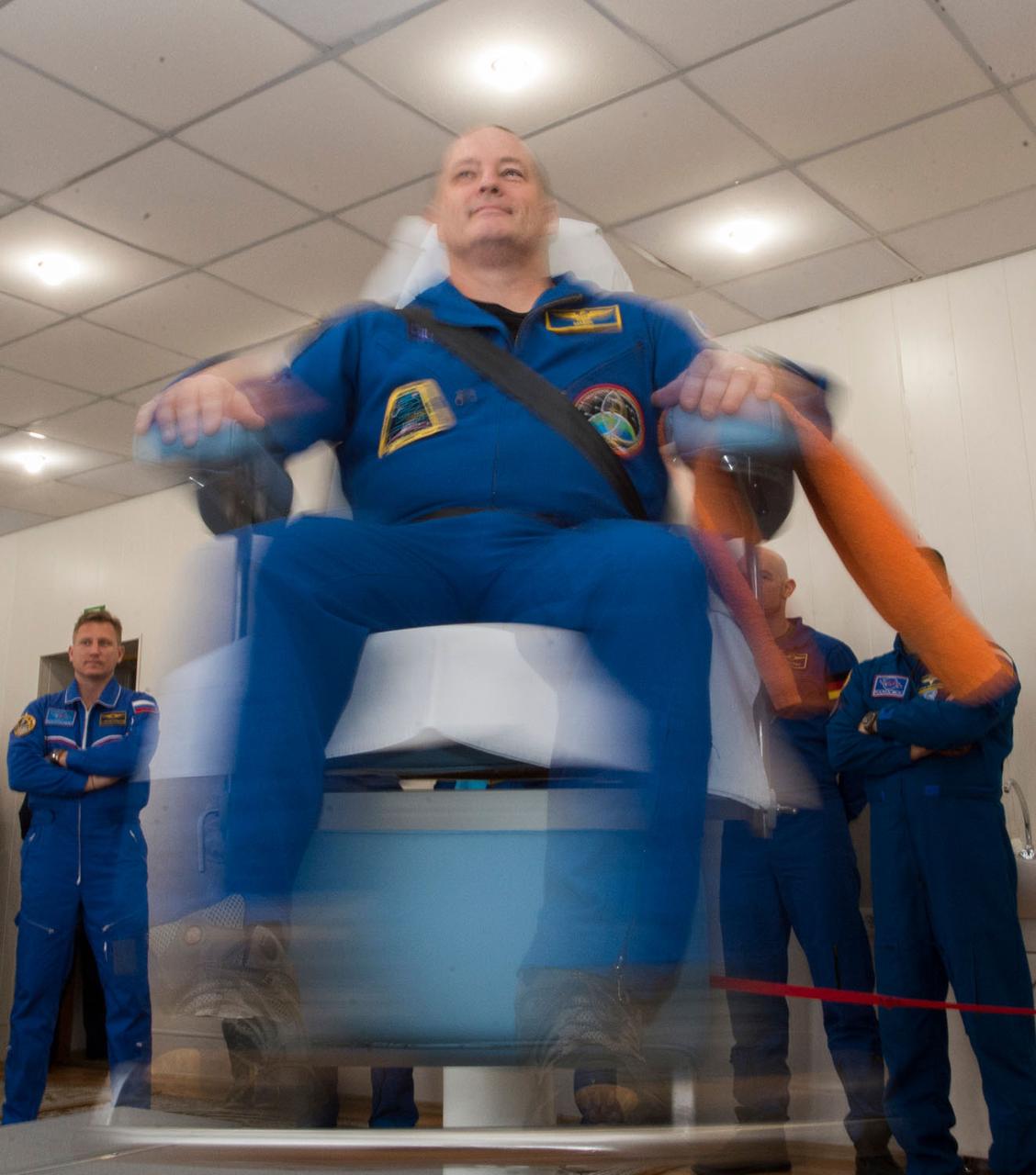 jsc2017e137339 - At the Cosmonaut Hotel crew quarters in Baikonur, Kazakhstan, Expedition 54-55 prime crewmember Scott Tingle of NASA tests his vestibular skills on a rotating chair Dec. 11 as part of his pre-launch training. Tingle, Norishige Kanai of the Japan Aerospace Exploration Agency (JAXA) and Anton Shkaplerov of the Russian Federal Space Agency (Roscosmos) will launch Dec. 17 on the Soyuz MS-07 spacecraft from the Baikonur Cosmodrome for a five month mission on the International Space Station...Andrey Shelepin / Gagarin Cosmonaut Training Center.