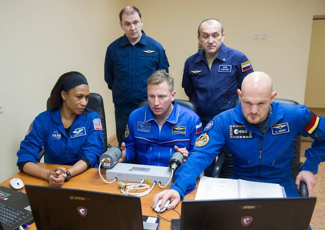 jsc2017e137340 - At their Cosmonaut Hotel crew quarters in Baikonur, Kazakhstan, Expedition 54-55 backup crewmembers Jeanette Epps of NASA (left), Sergey Prokopyev of the Russian Federal Space Agency (Roscosmos, center) and Alexander Gerst of the European Space Agency (right) conduct rendezvous and docking runs on a laptop computer simulator Dec. 11. They are serving as backups to Norishige Kanai of the Japan Aerospace Exploration Agency (JAXA), Anton Shkaplerov of Roscosmos and Scott Tingle of NASA who will launch Dec. 17 on the Soyuz MS-07 spacecraft from the Baikonur Cosmodrome for a five month mission on the International Space Station...Andrey Shelepin / Gagarin Cosmonaut Training Center.