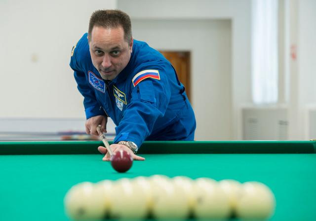 jsc2017e137344 - At the Cosmonaut Hotel crew quarters in Baikonur, Kazakhstan, Expedition 54-55 prime crewmember Anton Shkaplerov of the Russian Federal Space Agency (Roscosmos) tries his hand at a game of billiards Dec. 11 during a break in pre-launch training. Shkaplerov, Scott Tingle of NASA and Norishige Kanai of the Japan Aerospace Exploration Agency (JAXA) will launch Dec. 17 on the Soyuz MS-07 spacecraft from the Baikonur Cosmodrome for a five month mission on the International Space Station...Andrey Shelepin / Gagarin Cosmonaut Training Center.