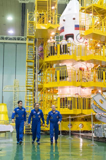 jsc2017e138115 - At the Integration Facility at the Baikonur Cosmodrome in Kazakhstan, Expedition 54-55 prime crewmembers Norishige Kanai of the Japan Aerospace Exploration Agency (JAXA, left), Anton Shkaplerov the Russian Federal Space Agency (Roscosmos, center) and Scott Tingle of NASA (right) walk from their Soyuz MS-07 spacecraft Dec. 13 at the conclusion of a second dress rehearsal fit check activity. They will launch Dec. 17 on the Soyuz MS-07 vehicle for a five month mission on the International Space Station...Andrey Shelepin/Gagarin Cosmonaut Training Center.