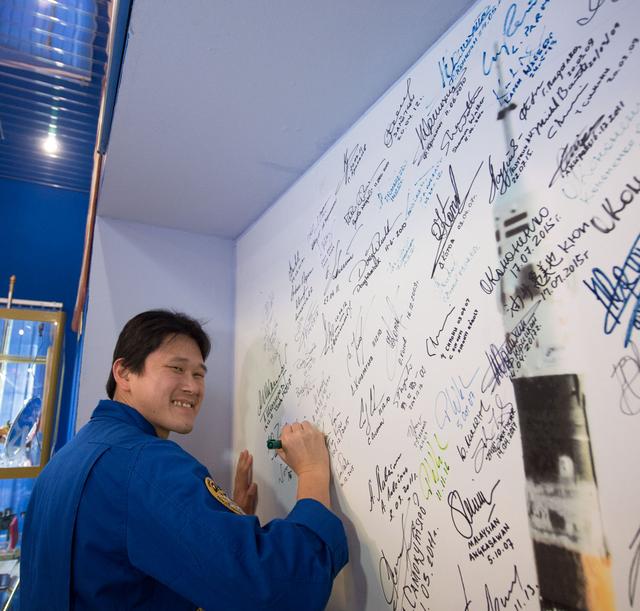 NASA image: jsc2017e138116 - At the Korolev Museum at the Baikonur Cosmodrome in Kazakhstan, Expedition 54-55 prime crewmember Norishige Kanai of the Japan Aerospace Exploration Agency (JAXA) signs a wall mural Dec. 13 as part of traditional pre-launch ceremonies. Ka