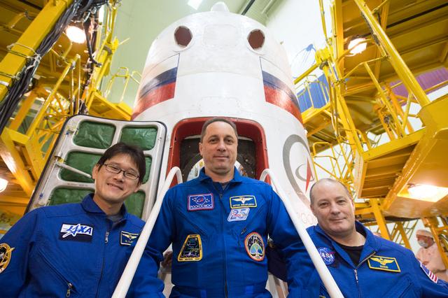 NASA image: jsc2017e138117 - At the Integration Facility at the Baikonur Cosmodrome in Kazakhstan, the Expedition 54-55 prime crewmembers pose for pictures Dec. 13 in front of the Soyuz MS-07 spacecraft during pre-launch training. Norishige Kanai of the Japan Aerospa