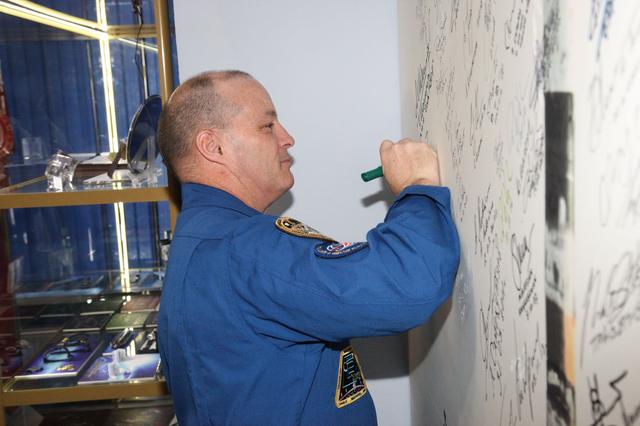 jsc2017e138129 - At the Korolev Museum at the Baikonur Cosmodrome in Kazakhstan, Expedition 54-55 prime crewmember Scott Tingle of NASA signs a wall mural Dec. 13 as part of traditional pre-launch ceremonies. Tingle, Anton Shkaplerov of the Russian Federal Space Agency (Roscosmos) and Norishige Kanai of the Japan Aerospace Exploration Agency (JAXA) will launch Dec. 17 on the Soyuz MS-07 spacecraft for a five month mission on the International Space Station...Andrey Shelepin/Gagarin Cosmonaut Training Center.