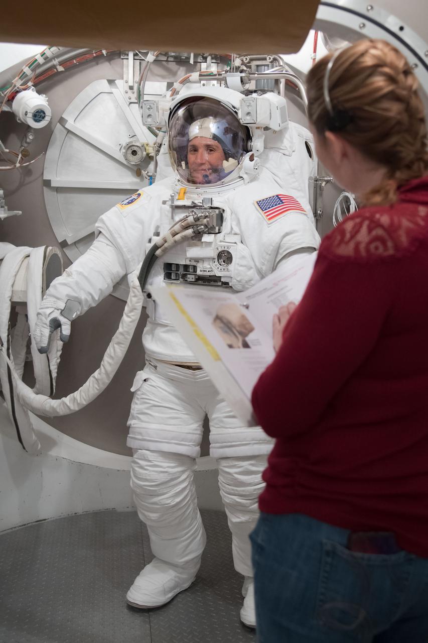 jsc2018e004976 (February 7, 2018) --- Expedition 56-57 crew member Serena Auñón-Chancellor of NASA trains inside the Space Station Airlock Test Article wearing an Extravehicular Mobility Unit, or U.S. spacesuit.
