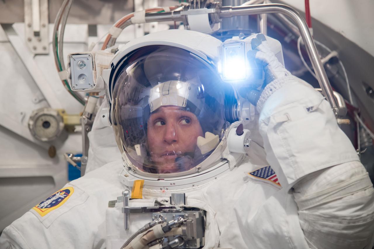 jsc2018e004977 (February 7, 2018) --- Expedition 56-57 crew member Serena Auñón-Chancellor of NASA trains inside the Space Station Airlock Test Article wearing an Extravehicular Mobility Unit, or U.S. spacesuit.