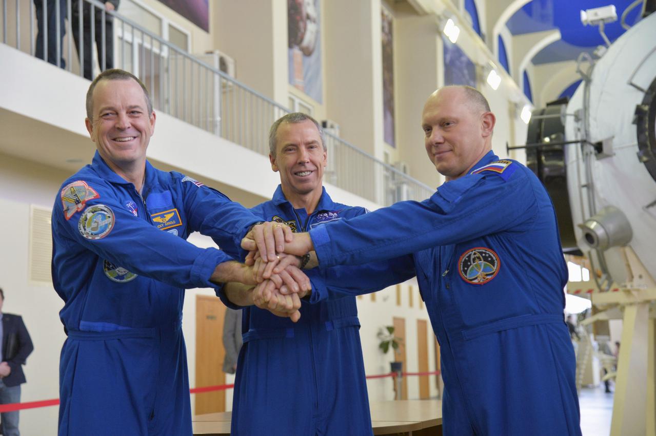 At the Gagarin Cosmonaut Training Center in Star City, Russia, Expedition 55 prime crewmembers Ricky Arnold and Drew Feustel of NASA (left and center) and Oleg Artemyev of Roscosmos (right) pose for pictures during a day of qualification exams Feb. 20. They will launch March 21 on the Soyuz MS-08 spacecraft from the Baikonur Cosmodrome in Kazakhstan for a five month mission on the International Space Station.  NASA/Elizabeth Weissinger