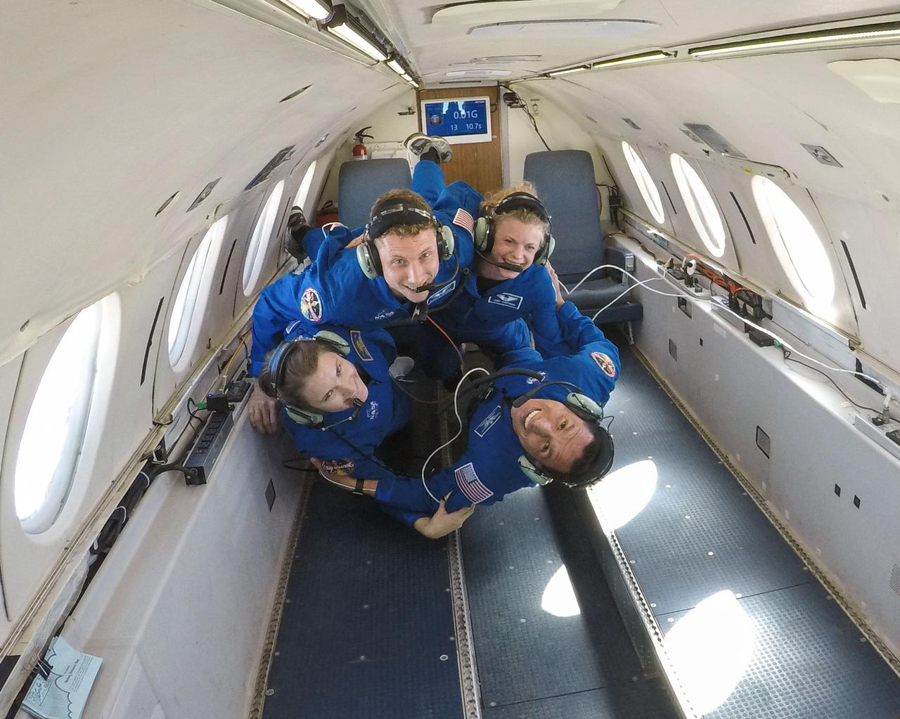 jsc2018e009094 (February 21, 2018) --- 2017 NASA astronaut candidates Warren Hoburg, Zena Cardman, Frank Rubio, and Kayla Barron latch on to each other during a reduced gravity flight aboard Canadian Space Agency’s Dassault Falcon 20 Jet. Photo Credit: (NASA/Robert Markowitz)