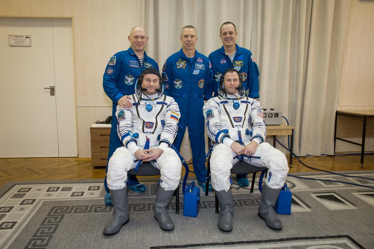 jsc2018e010881 - At the Baikonur Cosmodrome in Kazakhstan, the Expedition 55 backup and prime crewmembers pose for pictures March 5 as part of the crew’s first vehicle fit check activities. In the front row are the backup crewmembers, Alexey Ovchinin of Roscosmos (left) and Nick Hague of NASA (right). In the back row are the prime crewmembers, Oleg Artemyev of Roscosmos (left), Drew Feustel of NASA (center) and Ricky Arnold of NASA (right), who will launch March 21 in the Soyuz MS-08 spacecraft from Baikonur for a five-month mission on the International Space Station...NASA/Victor Zelentsov.