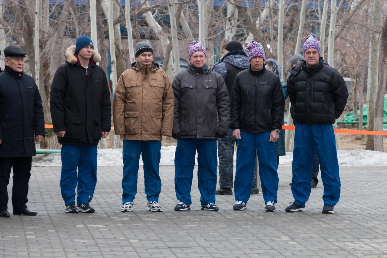 At their Cosmonaut Hotel crew quarters in Baikonur, Kazakhstan, the Expedition 55 prime and backup crewmembers attend a traditional flag raising ceremony March 6. From the second from the left are backup crewmembers Nick Hague of NASA and Alexey Ovchinin o
