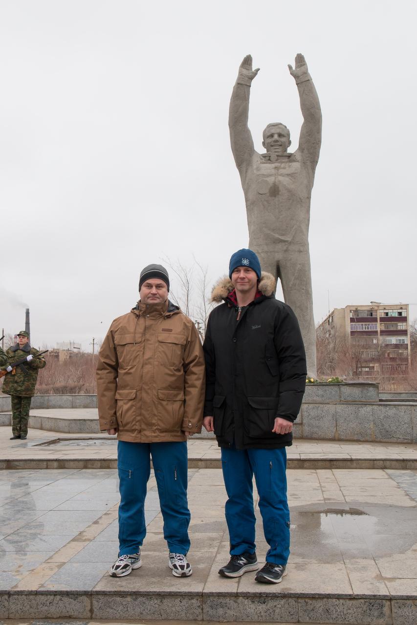 In the city of Baikonur, Kazakhstan, Expedition 55 backup crewmembers Alexey Ovchinin of Roscosmos (left) and Nick Hague of NASA (right) pose for pictures March 6 in front of a statue of Yuri Gagarin, the first human to fly in space, during traditional pre