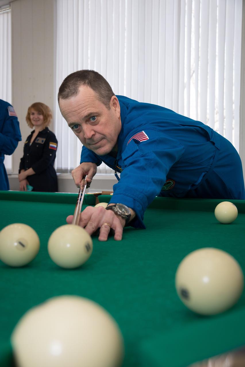 jsc2018e025554 - At the Cosmonaut Hotel crew quarters in Baikonur, Kazakhstan, Expedition 55 crewmember Ricky Arnold of NASA tries his hand at billiards March 15 as part of pre-launch activities. Arnold, Drew Feustel of NASA and Oleg Artemyev of Roscosmos will launch March 21 on the Soyuz MS-08 spacecraft from the Baikonur Cosmodrome on a five-month mission to the International Space Station...NASA/Victor Zelentsov.