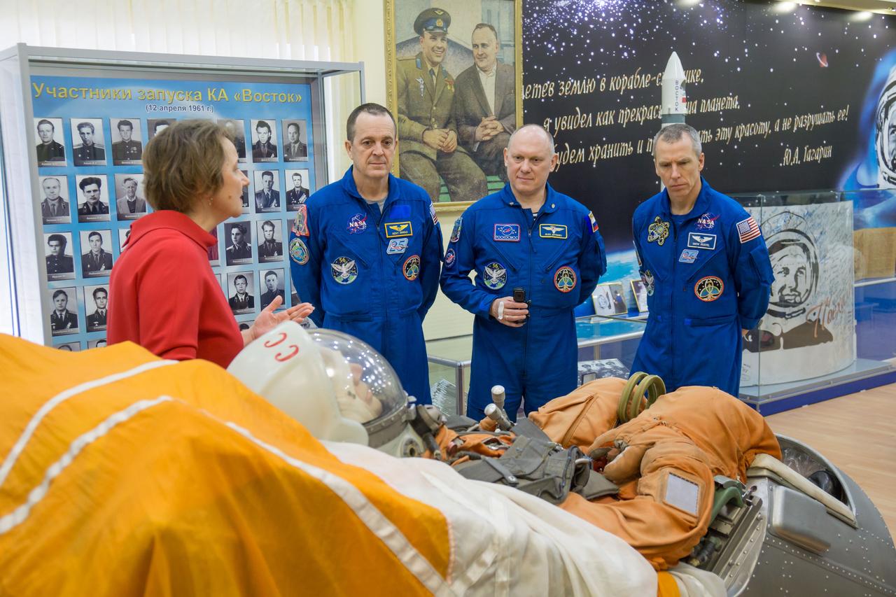jsc2018e025589 - In the Korolev Museum at the Baikonur Cosmodrome in Kazakhstan, Expedition 55 crewmembers Ricky Arnold of NASA (left), Oleg Artemyev of Roscosmos (center) and Drew Feustel of NASA (right) are shown a mockup of a Soyuz spacecraft seat March 16 during a traditional preflight tour of the museum. They will launch March 21 on the Soyuz MS-08 spacecraft for a five-month mission on the International Space Station...NASA/Victor Zelentsov.