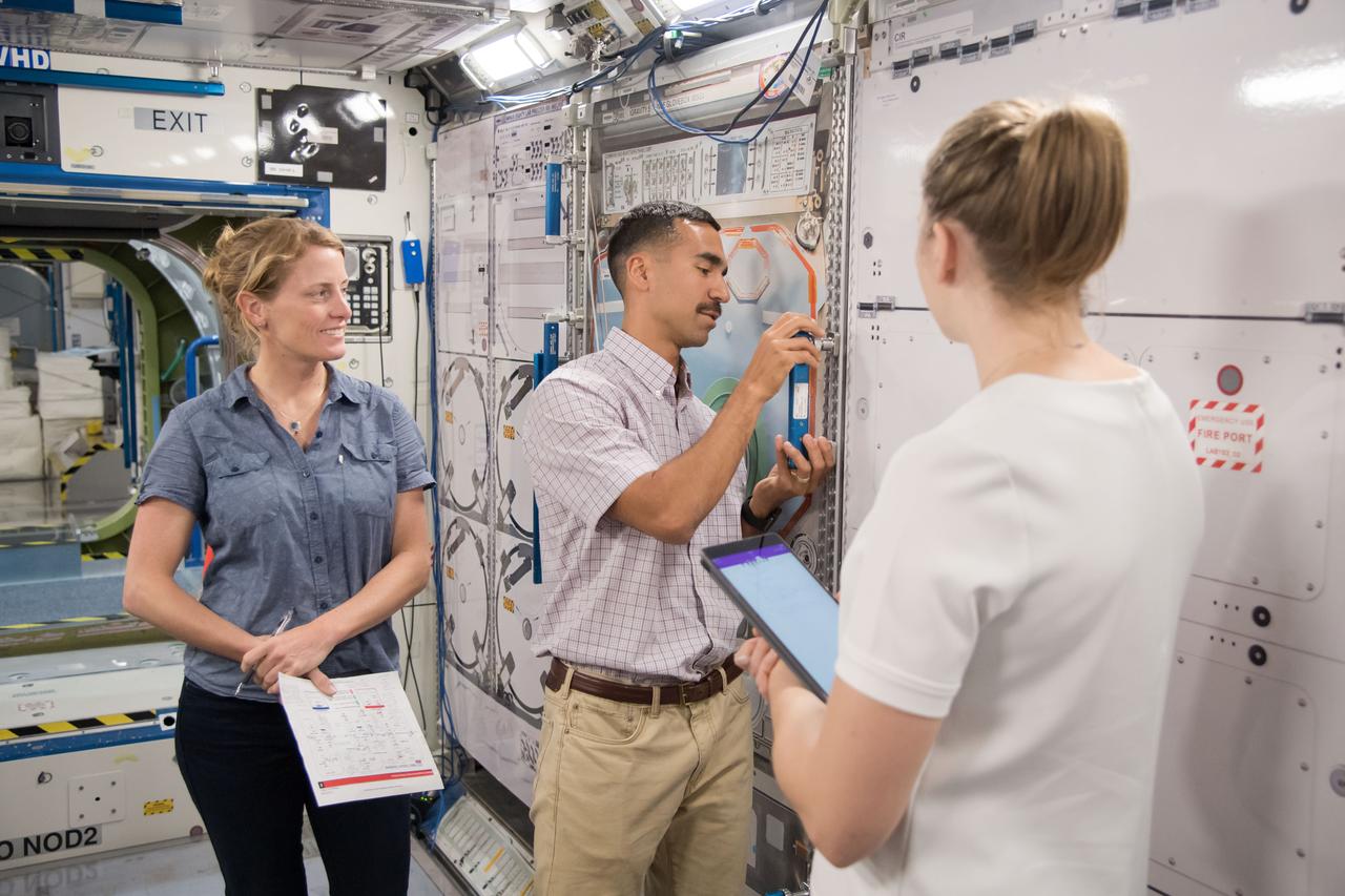 jsc2018e029685 (March 26, 2018) --- 2017 NASA astronaut candidates Loral O’Hara (left), Raja Chari (center), and Kayla Barron (right) learn about International Space Station tools and systems with trainers in NASA Johnson Space Center’s Space Vehicle Mockup Facility in Houston. Photo Credit: (NASA/Josh Valcarcel)