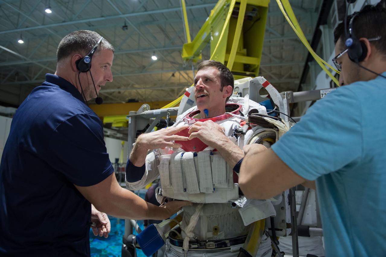 jsc2018e035765 (04-12-2018) --- 2017 Canadian Space Agency astronaut candidate Joshua Kutryk suits up in a spacesuit for underwater spacewalk training at NASA Johnson Space Center’s Neutral Buoyancy Laboratory. Photo Credit: (NASA/David DeHoyos)
