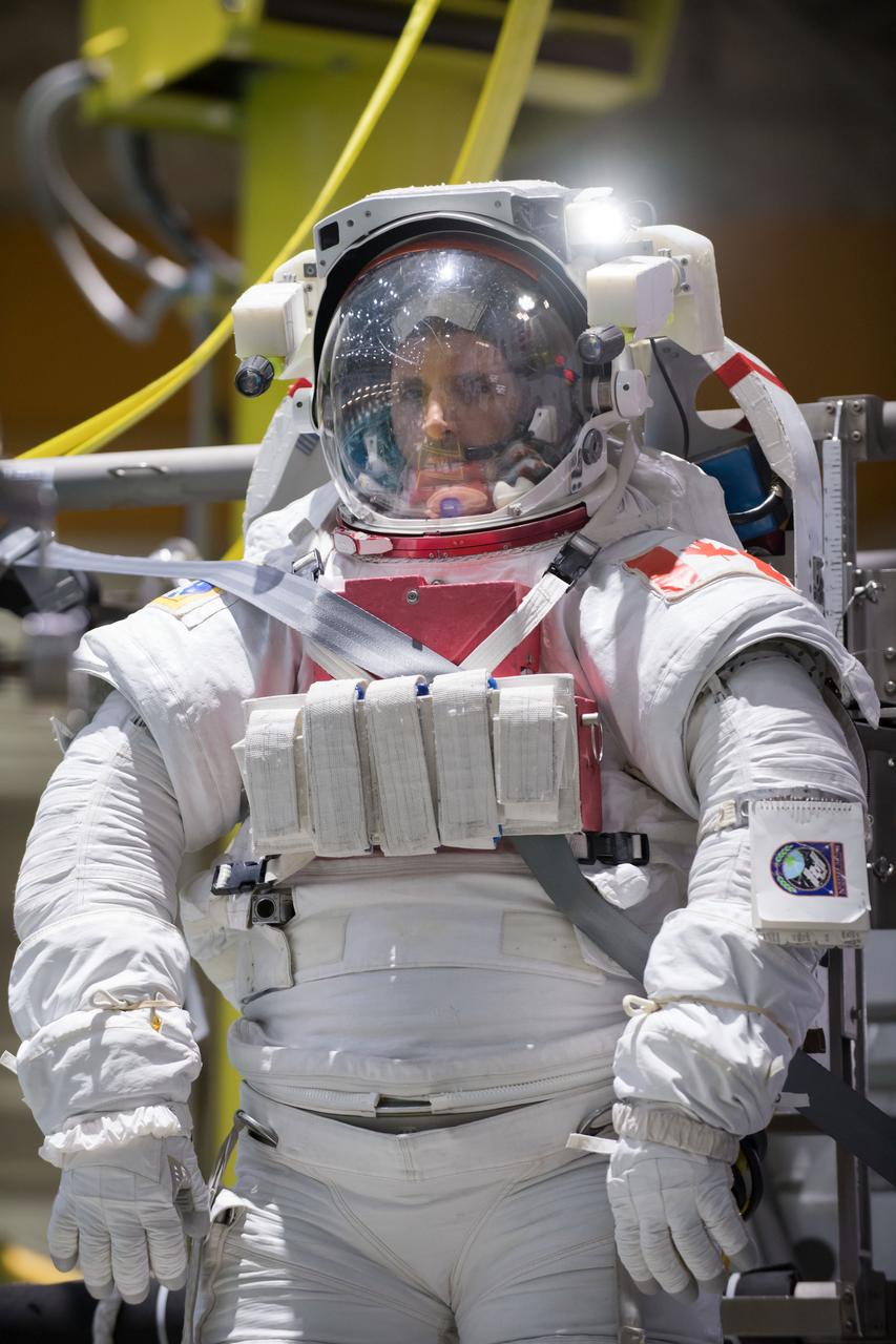 jsc2018e035788 (04-12-2018) --- Canadian Space Agency astronaut candidate Joshua Kutryk is in a spacesuit prior to underwater spacewalk training at NASA Johnson Space Center’s Neutral Buoyancy Laboratory. NASA astronaut candidate Zena Cardman is being helped into a spacesuit for  underwater spacewalk training at NASA Johnson Space Center’s Neutral Buoyancy Laboratory.