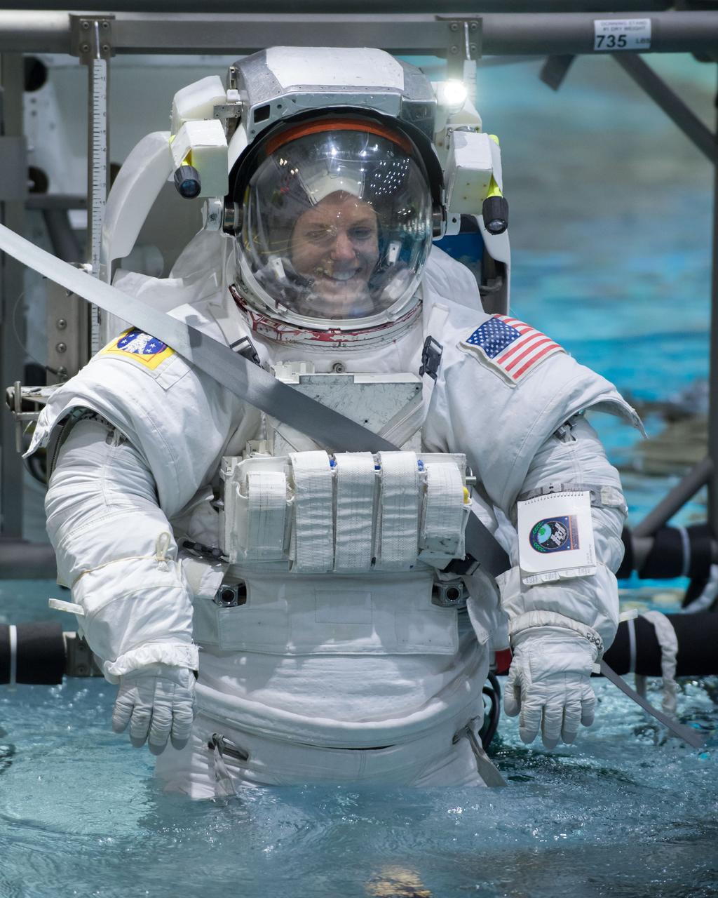 jsc2018e035796 (04-12-2018) --- NASA astronaut candidate Zena Cardman in a spacesuit is lowered into the training pool at NASA Johnson Space Center’s Neutral Buoyancy Laboratory. Photo Credit: (NASA/David DeHoyos)