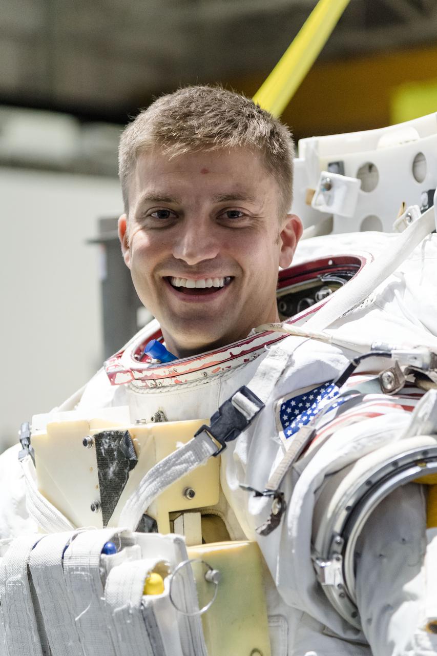 jsc2018e035904 (April 11, 2018) --- 2017 NASA astronaut candidate Matthew Dominick wears a spacesuit prior to underwater spacewalk training at NASA Johnson Space Center’s Neutral Buoyancy Laboratory. Photo Credit: (NASA/Josh Valcarcel)