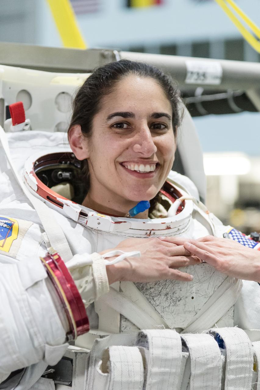 jsc2018e035910 (April 11, 2018) --- 2017 NASA astronaut candidate Jasmin Moghbeli wears a spacesuit prior to underwater spacewalk training at NASA’s Johnson Space Center Neutral Buoyancy Laboratory. Photo Credit: (NASA/Josh Valcarcel)