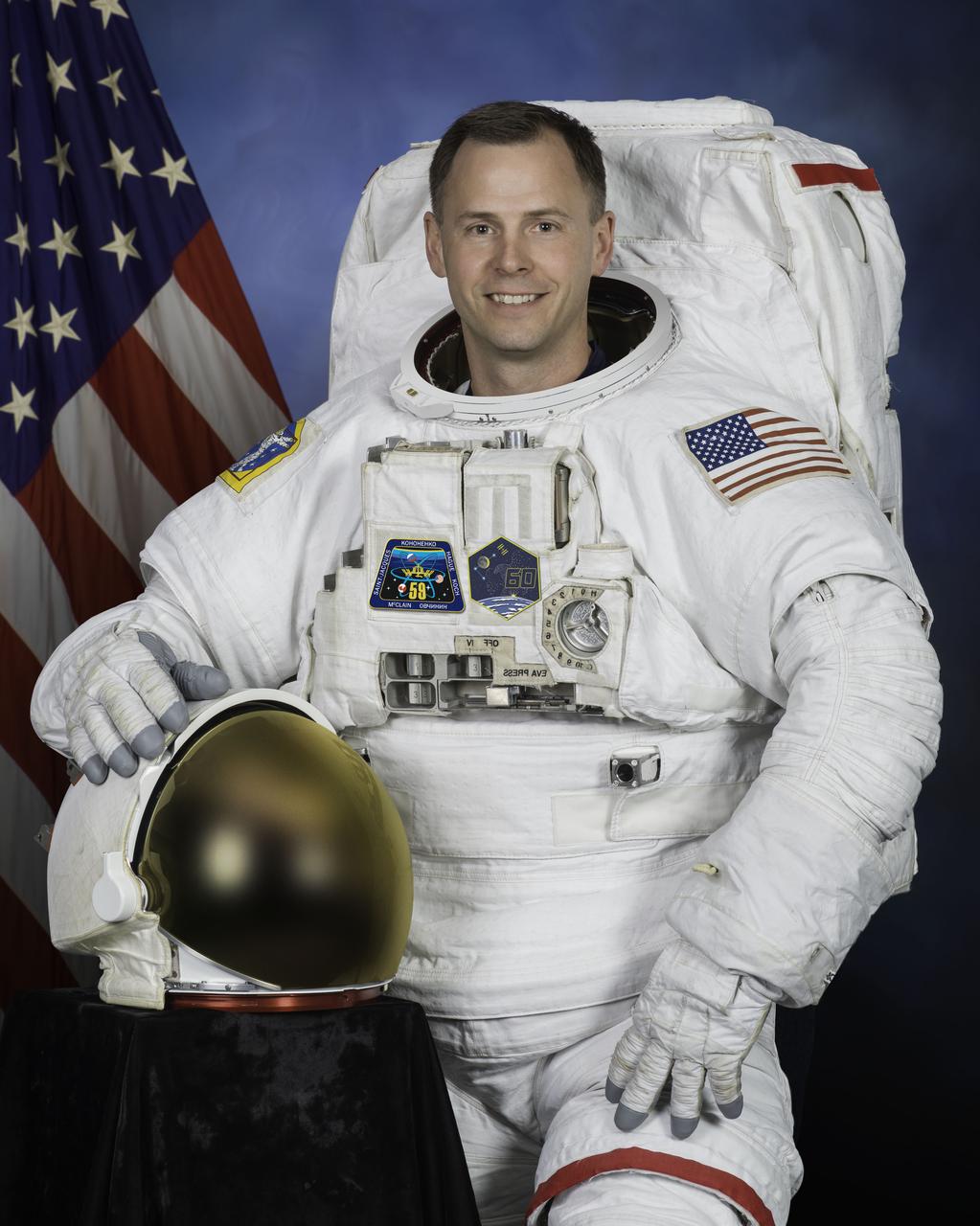 jsc2018e037944_alt2 (May 31, 2018) --- Official portrait of NASA astronaut Nick Hague in a U.S. spacesuit, also known as an Extravehicular Mobility Unit (EMU).
