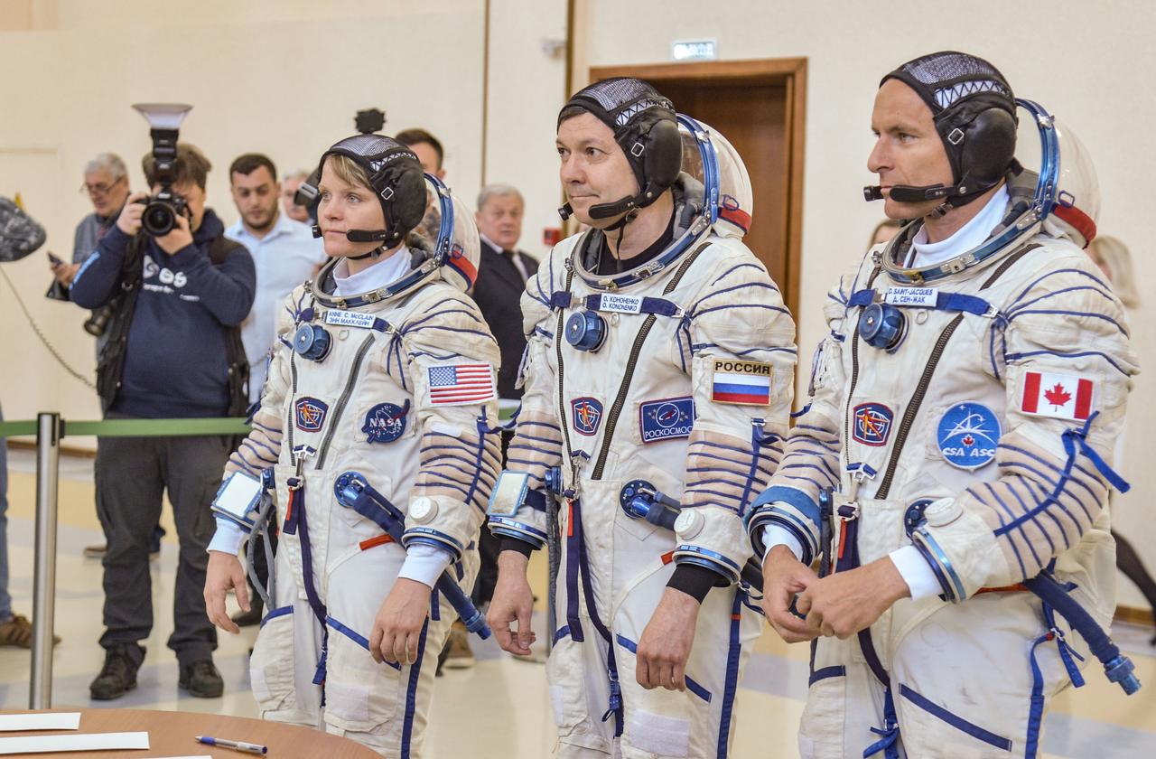 jsc2018e043403 (May 10, 2018) --- At the Gagarin Cosmonaut Training Center in Star City, Russia, Expedition 56 backup crew members Anne McClain of NASA (left), Oleg Kononenko of Roscosmos (center) and David Saint-Jacques of the Canadian Space Agency (right) report for their final Soyuz spacecraft qualification exams May 10. They are the backups to the prime crew of Serena Aunon-Chancellor of NASA, Sergey Prokopyev of Roscosmos and Alexander Gerst of the European Space Agency, who will launch June 6 from the Baikonur Cosmodrome in Kazakhstan on the Soyuz MS-09 spacecraft for a six-month mission on the International Space Station...NASA/Elizabeth Weissinger.