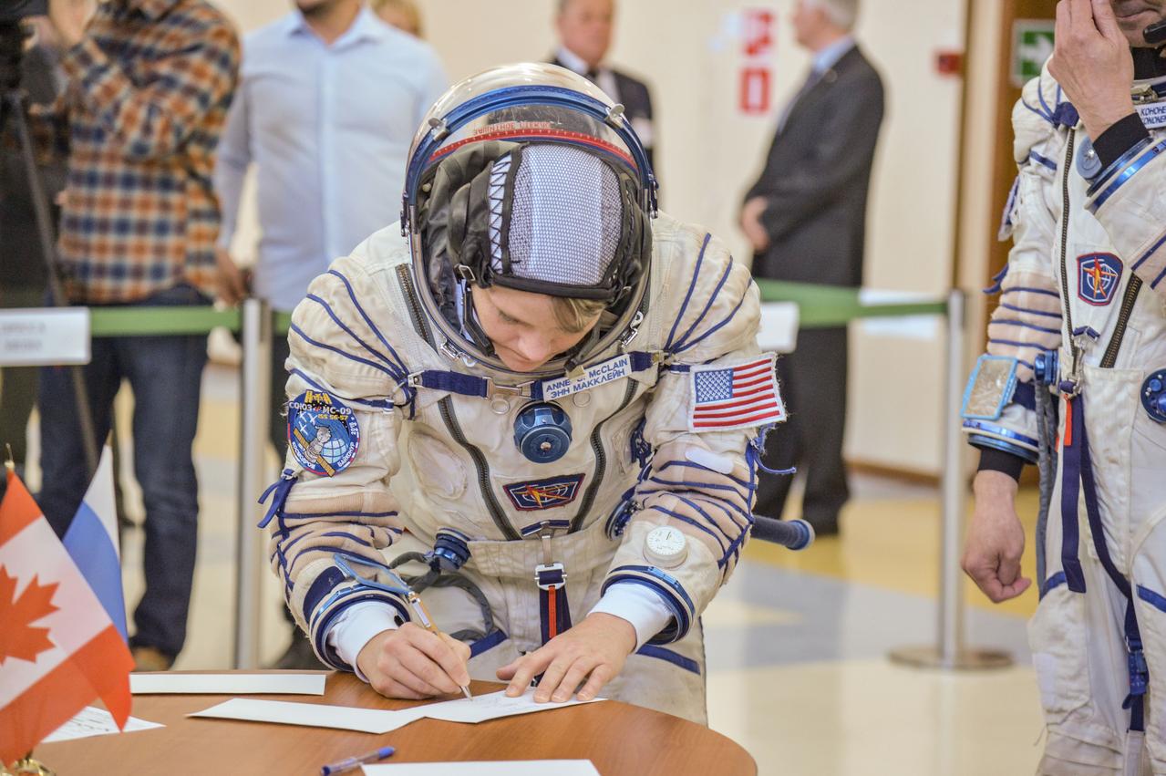 jsc2018e043406 (May 10, 2018) --- At the Gagarin Cosmonaut Training Center in Star City, Russia, Expedition 56 backup crew member Anne McClain of NASA signs in for her final Soyuz qualification exam May 10. McClain, Oleg Kononenko of Roscosmos and David Saint-Jacques of the Canadian Space Agency are the backups to the prime crew of Serena Aunon-Chancellor of NASA, Sergey Prokopyev of Roscosmos and Alexander Gerst of the European Space Agency, who will launch June 6 from the Baikonur Cosmodrome in Kazakhstan on the Soyuz MS-09 spacecraft for a six-month mission on the International Space Station...NASA/Elizabeth Weissinger.
