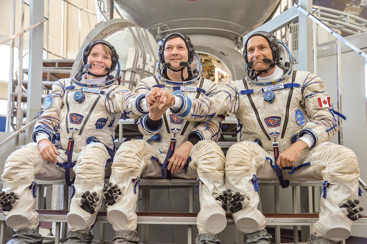 jsc2018e043409 (May 10, 2018) --- At the Gagarin Cosmonaut Training Center in Star City, Russia, Expedition 56 backup crew members Anne McClain of NASA (left), Oleg Kononenko of Roscosmos (center) and David Saint-Jacques of the Canadian Space Agency (right) pose for pictures May 10 following their final Soyuz spacecraft qualification exams. They are the backups to the prime crew of Serena Aunon-Chancellor of NASA, Sergey Prokopyev of Roscosmos and Alexander Gerst of the European Space Agency, who will launch June 6 from the Baikonur Cosmodrome in Kazakhstan on the Soyuz MS-09 spacecraft for a six-month mission on the International Space Station...NASA/Elizabeth Weissinger.