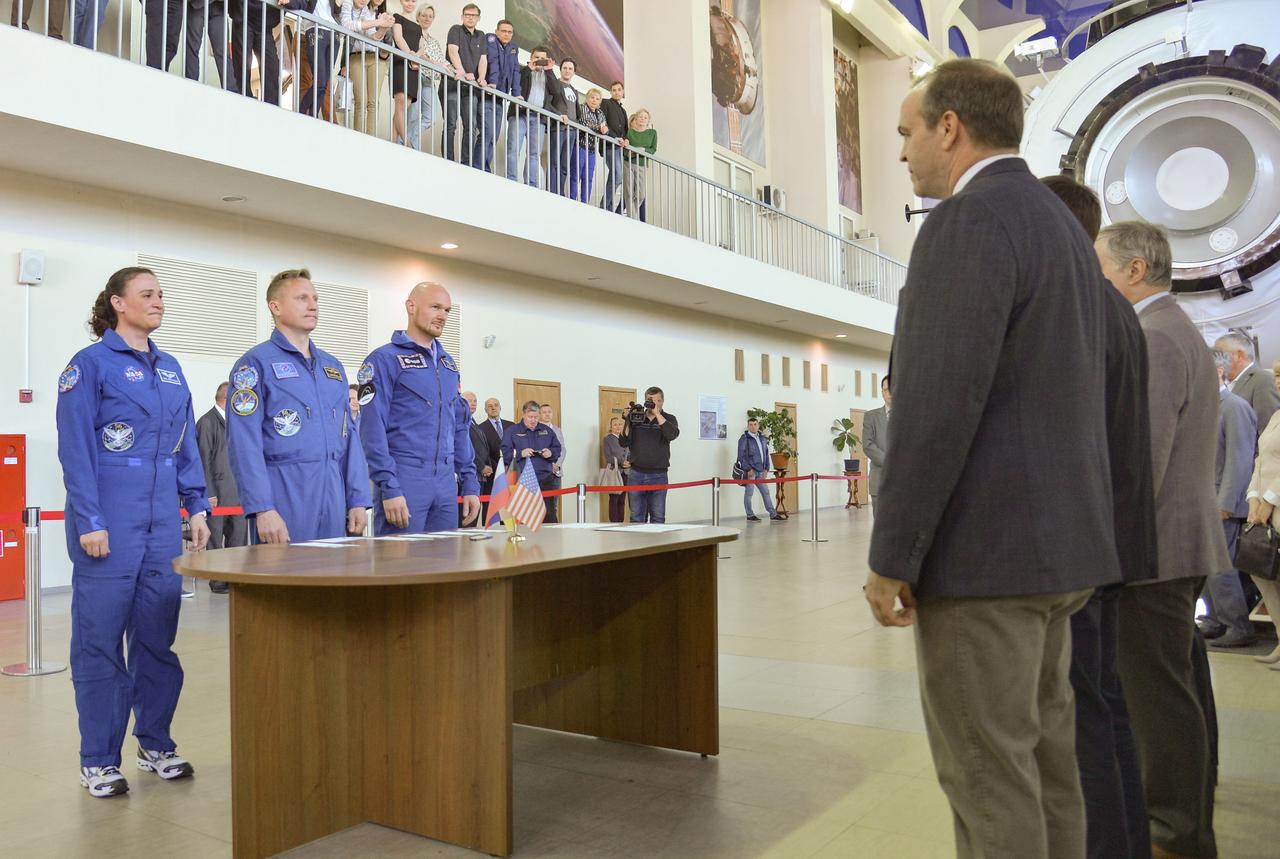 jsc2018e043410 (May 10, 2018) --- At the Gagarin Cosmonaut Training Center in Star City, Russia, Expedition 56 prime crew members Serena Aunon-Chancellor of NASA (left), Sergey Prokopyev of Roscosmos (center) and Alexander Gerst of the European Space Agency (right) report to Russian, American and European space officials May 10 at the start of their final Soyuz qualification exams. They will launch June 6 from the Baikonur Cosmodrome in Kazakhstan on the Soyuz MS-09 spacecraft for a six-month mission on the International Space Station...NASA/Elizabeth Weissinger.