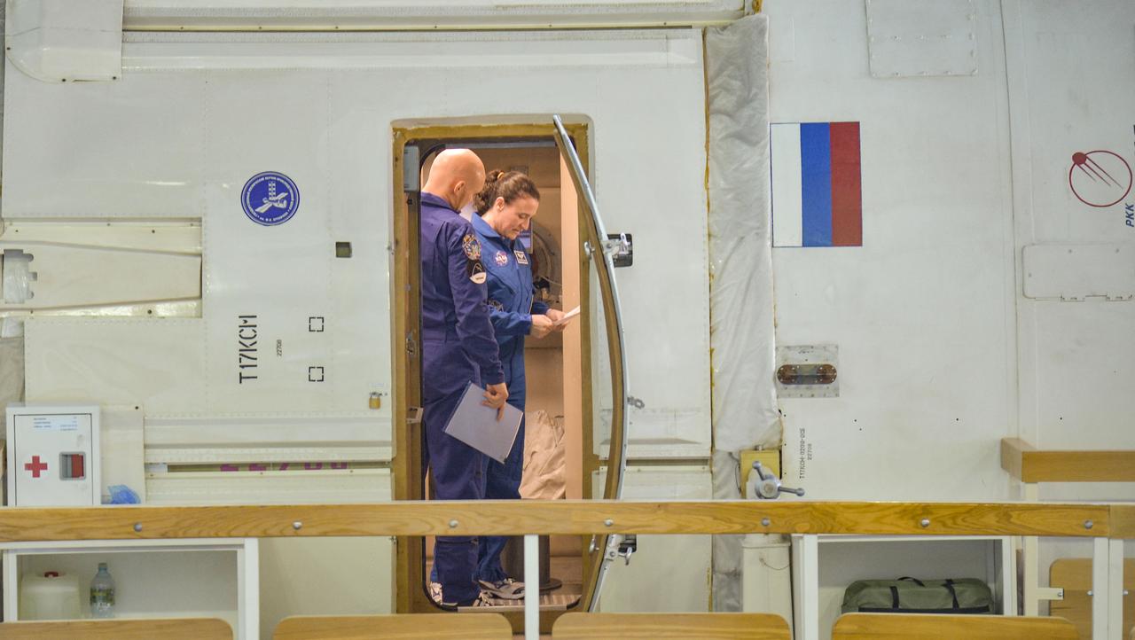 jsc2018e043417 (May 10, 2018) --- At the Gagarin Cosmonaut Training Center in Star City, Russia, Expedition 56 prime crew members Alexander Gerst of the European Space Agency (left) and Serena Aunon-Chancellor of NASA (right) review procedures in a Russian segment mockup May 10 as part of their final flight qualification exams. Gerst, Aunon-Chancellor and Sergey Prokopyev of Roscosmos will launch June 6 from the Baikonur Cosmodrome in Kazakhstan on the Soyuz MS-09 spacecraft for a six-month mission on the International Space Station...NASA/Elizabeth Weissinger.