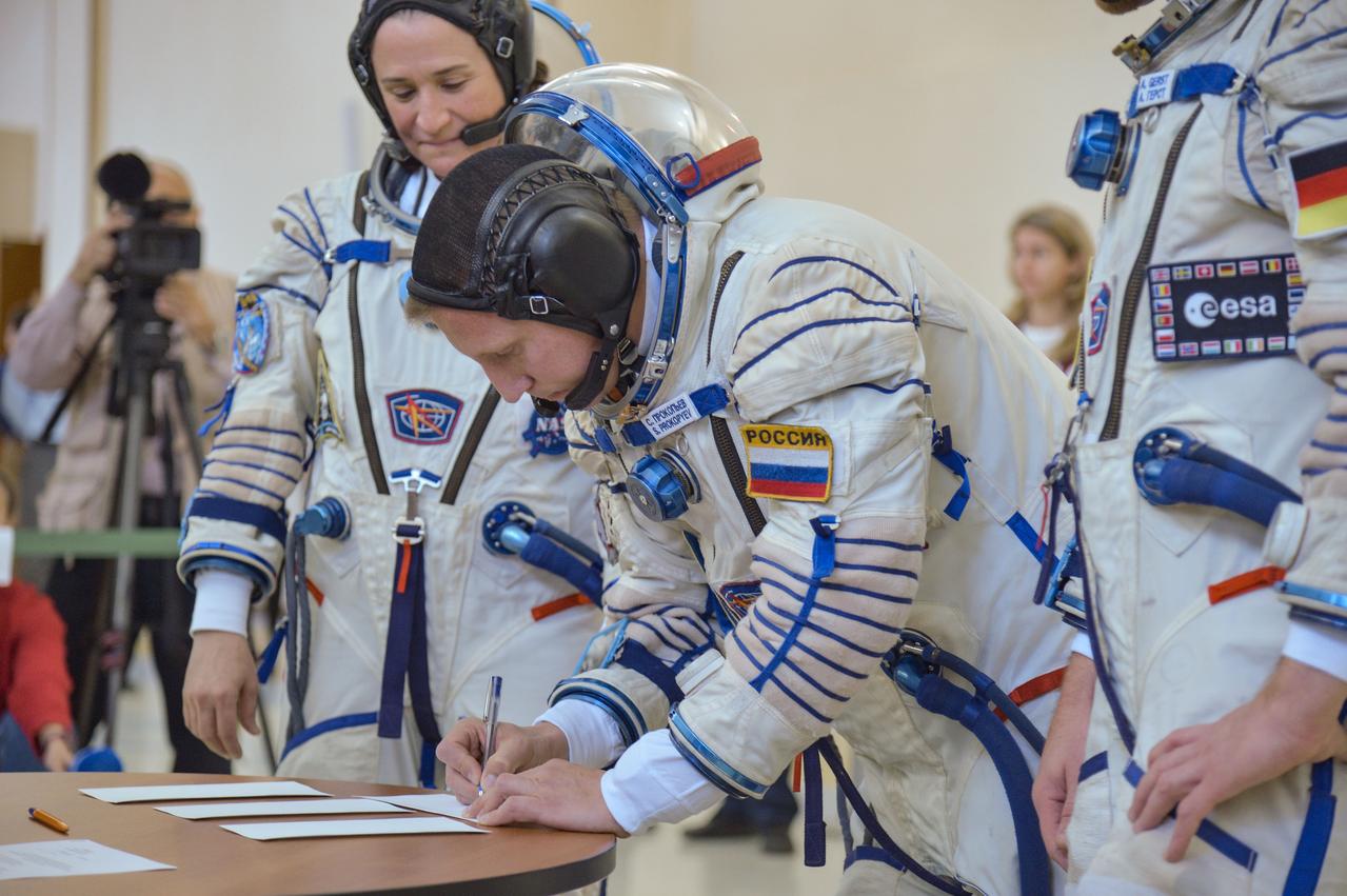 jsc2018e044090 - At the Gagarin Cosmonaut Training Center in Star City, Russia, Expedition 56 crewmember Sergey Prokopyev of Roscosmos signs in for the final day of Soyuz qualification exams May 11. Looking on is his crewmate, NASA’s Serena Aunon-Chancellor. Prokopyev, Aunon-Chancellor and Alexander Gerst of the European Space Agency will launch June 6 on the Soyuz MS-09 spacecraft from the Baikonur Cosmodrome in Kazakhstan for a six-month mission on the International Space Station...NASA/Elizabeth Weissinger.