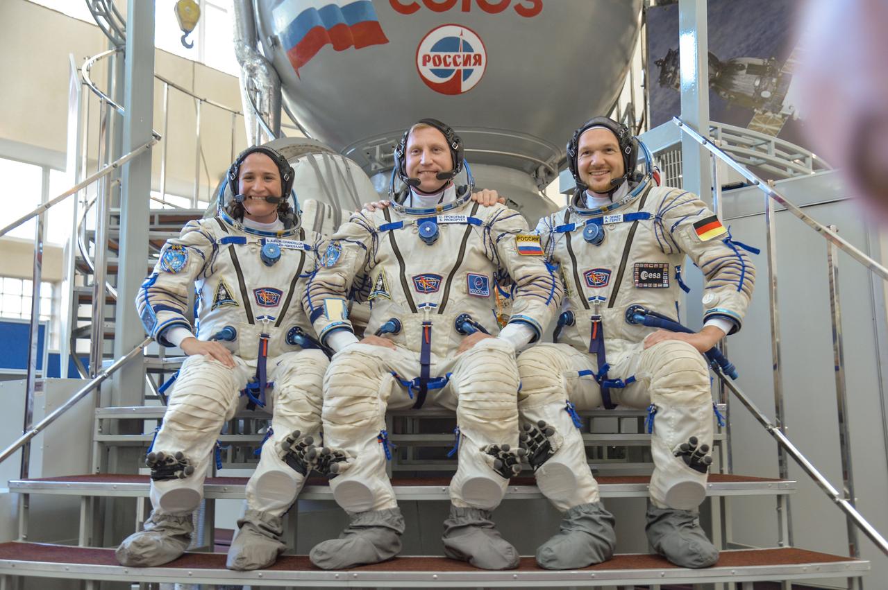 jsc2018e044094 - At the Gagarin Cosmonaut Training Center in Star City, Russia, Expedition 56 crewmembers Serena Aunon-Chancellor of NASA (left), Sergey Prokopyev of Roscosmos (center) and Alexander Gerst of the European Space Agency (right) pose for pictures in front of a Soyuz simulator May 11 during the final day of their vehicle qualification exams. They will launch June 6 on the Soyuz MS-09 spacecraft from the Baikonur Cosmodrome in Kazakhstan for a six-month mission on the International Space Station...NASA/Elizabeth Weissinger.