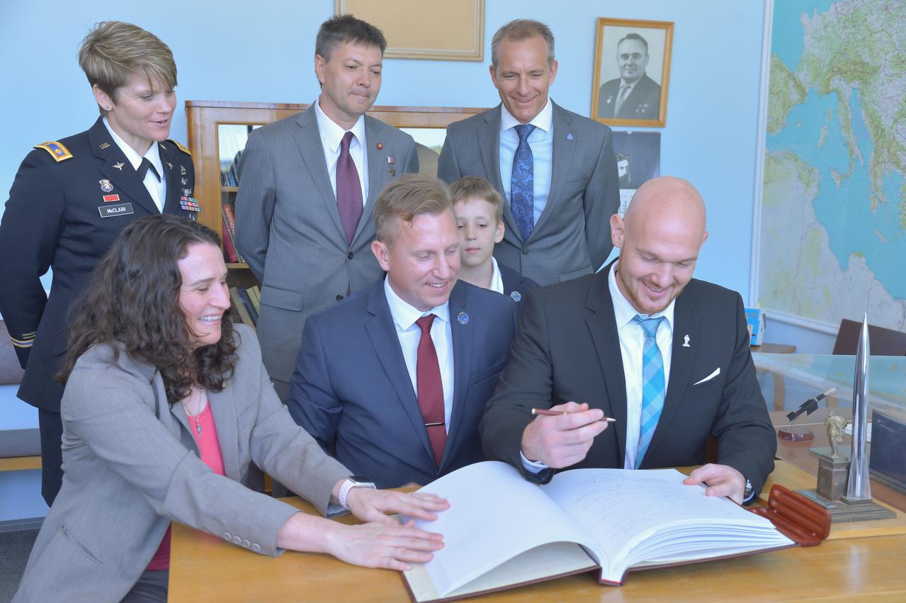 jsc2018e048498 - At the Gagarin Cosmonaut Training Center in Star City, Russia, Expedition 56 prime crewmember Alexander Gerst of the European Space Agency (front, right) signs a ceremonial book May 14 as part of pre-launch activities. Joining him in the front row are crewmates Serena Aunon-Chancellor of NASA (front, left) and Sergey Prokopyev of Roscosmos (front, center). Looking on in the back row are backup crewmembers Anne McClain of NASA (left), Oleg Kononenko of Roscosmos (center) and David Saint-Jacques of the Canadian Space Agency. Aunon-Chancellor, Gerst and Prokopyev will launch June 6 from the Baikonur Cosmodrome in Kazakhstan on the Soyuz MS-09 spacecraft for a six month mission on the International Space Station...NASA/Elizabeth Weissinger.