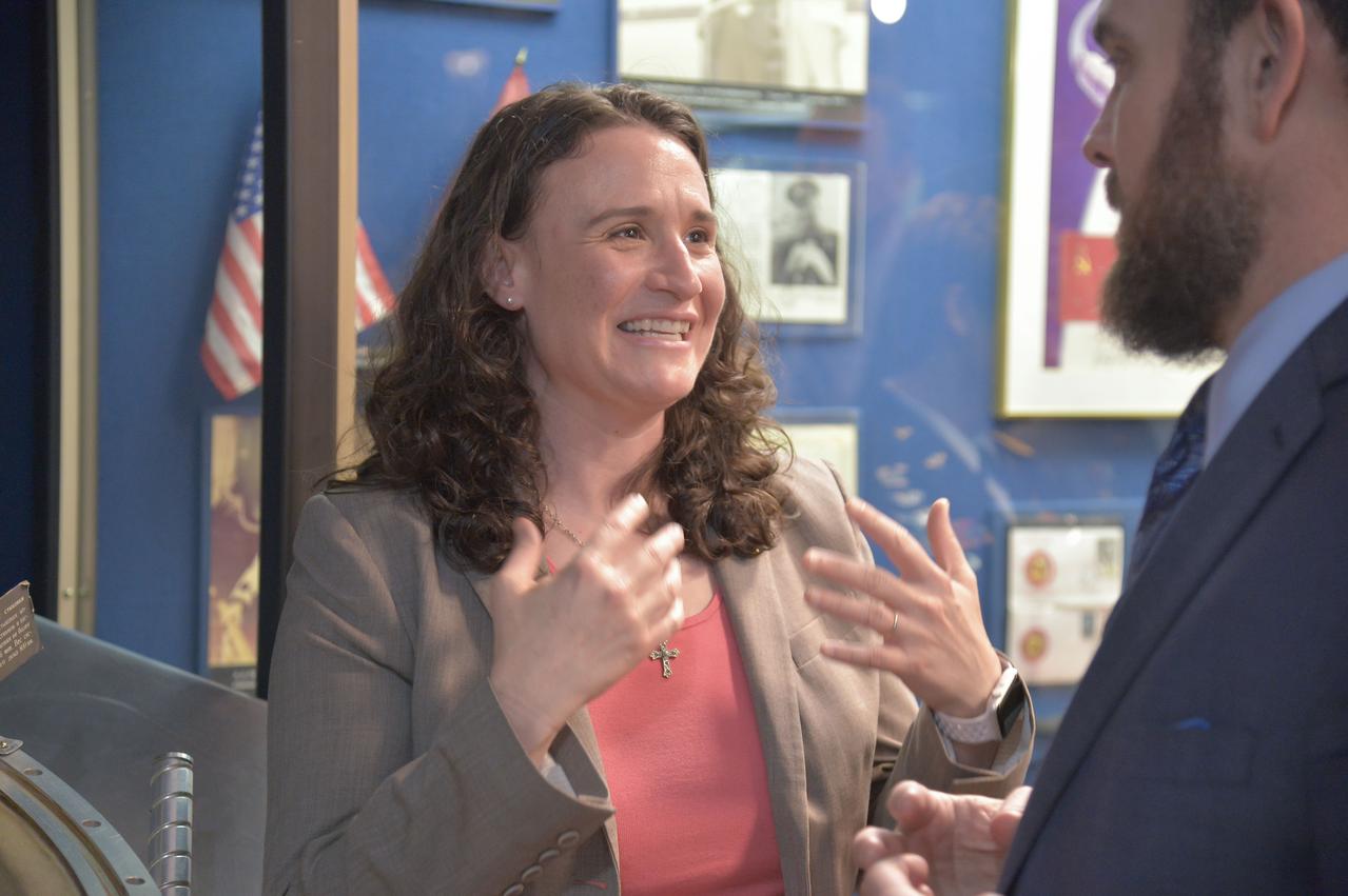 jsc2018e048499 - In the Gagarin Museum at the Gagarin Cosmonaut Training Center in Star City, Russia, Expedition 56 crewmember Serena Aunon-Chancellor of NASA gestures during a conversation with her husband May 14 in the midst of pre-launch activities. Aunon-Chancellor, Alexander Gerst of the European Space Agency and Sergey Prokopyev of Roscosmos will launch June 6 from the Baikonur Cosmodrome in Kazakhstan on the Soyuz MS-09 spacecraft for a six month mission on the International Space Station...NASA/Elizabeth Weissinger.