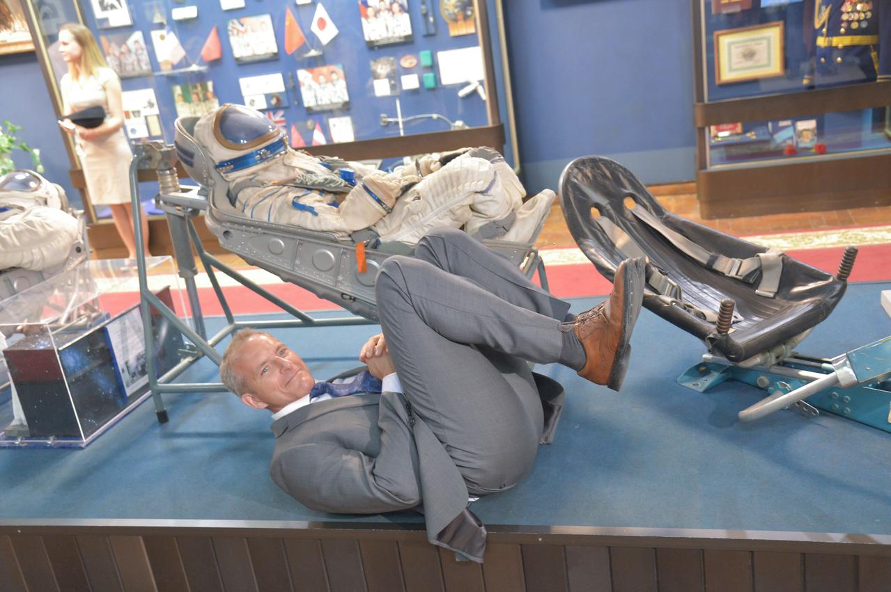 jsc2018e048500 - In the Gagarin Museum at the Gagarin Cosmonaut Training Center in Star City, Russia May 14, Expedition 56 backup crewmember David Saint-Jacques of the Canadian Space Agency mimics the position he will be in when he launches aboard a Soyuz rocket later this year during pre-launch activities. Saint-Jacques is serving as a backup to prime crewmembers Serena Aunon-Chancellor of NASA, Alexander Gerst of the European Space Agency and Sergey Prokopyev of Roscosmos, who will launch June 6 from the Baikonur Cosmodrome in Kazakhstan on the Soyuz MS-09 spacecraft for a six month mission on the International Space Station...NASA/Elizabeth Weissinger.