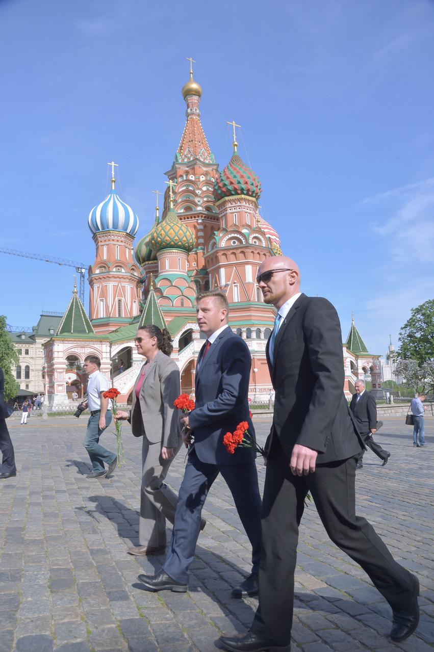 jsc2018e048501 - Walking in front of St. Basil’s Cathedral at Red Square in Moscow May 14, Expedition 56 crewmembers Serena Aunon-Chancellor of NASA (left), Sergey Prokopyev of Roscosmos (center) and Alexander Gerst of the European Space Agency (right) prepare to lay flowers at the Kremlin Wall where Russian space icons are interred. They will launch June 6 from the Baikonur Cosmodrome in Kazakhstan on the Soyuz MS-09 spacecraft for a six month mission on the International Space Station...NASA/Elizabeth Weissinger.