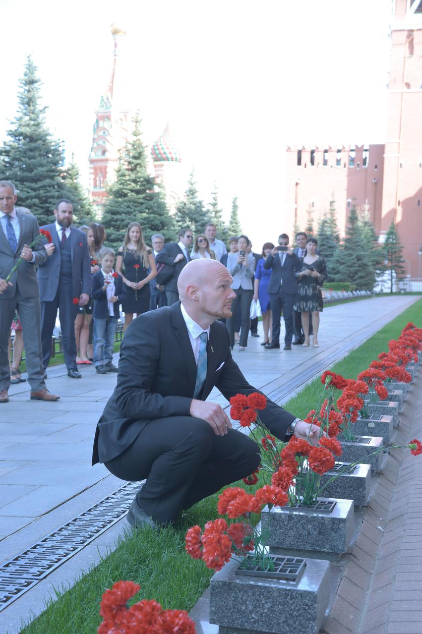 jsc2018e048504 - At the Kremlin Wall in Red Square in Moscow May 14, Expedition 56 crewmember Alexander Gerst of the European Space Agency lays flowers where Russian space icons are interred as part of traditional pre-launch ceremonies. Gerst, Serena Aunon-Chancellor of NASA and Sergey Prokopyev of Roscosmos will launch June 6 from the Baikonur Cosmodrome in Kazakhstan on the Soyuz MS-09 spacecraft for a six month mission on the International Space Station...NASA/Elizabeth Weissinger.