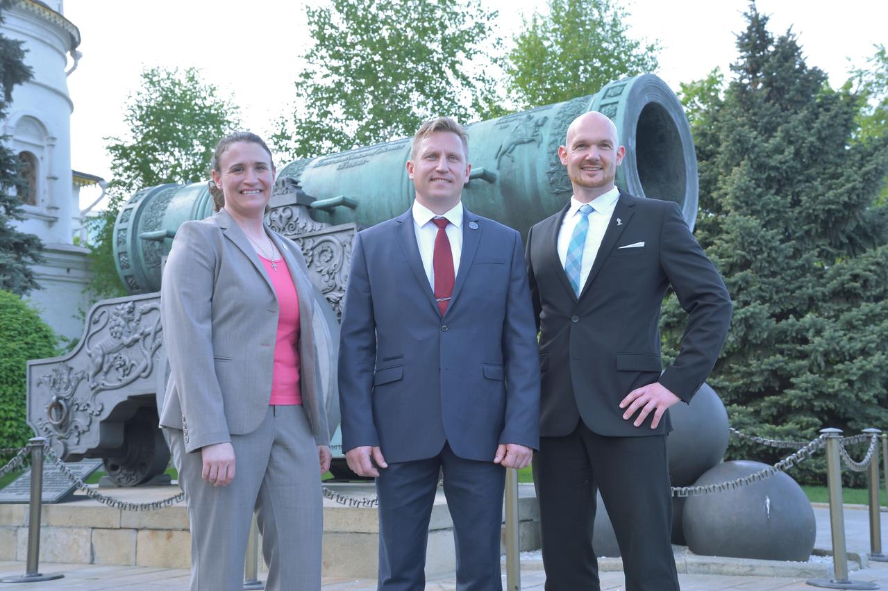 jsc2018e048509 - Expedition 56 crewmembers Serena Aunon-Chancellor of NASA (left), Sergey Prokopyev of Roscosmos (center) and Alexander Gerst of the European Space Agency (right) pose for pictures in front of the Tsar Cannon at the Kremlin in Moscow May 14 as part of traditional pre-launch activities. They will launch June 6 from the Baikonur Cosmodrome in Kazakhstan on the Soyuz MS-09 spacecraft for a six month mission on the International Space Station...NASA/Elizabeth Weissinger.