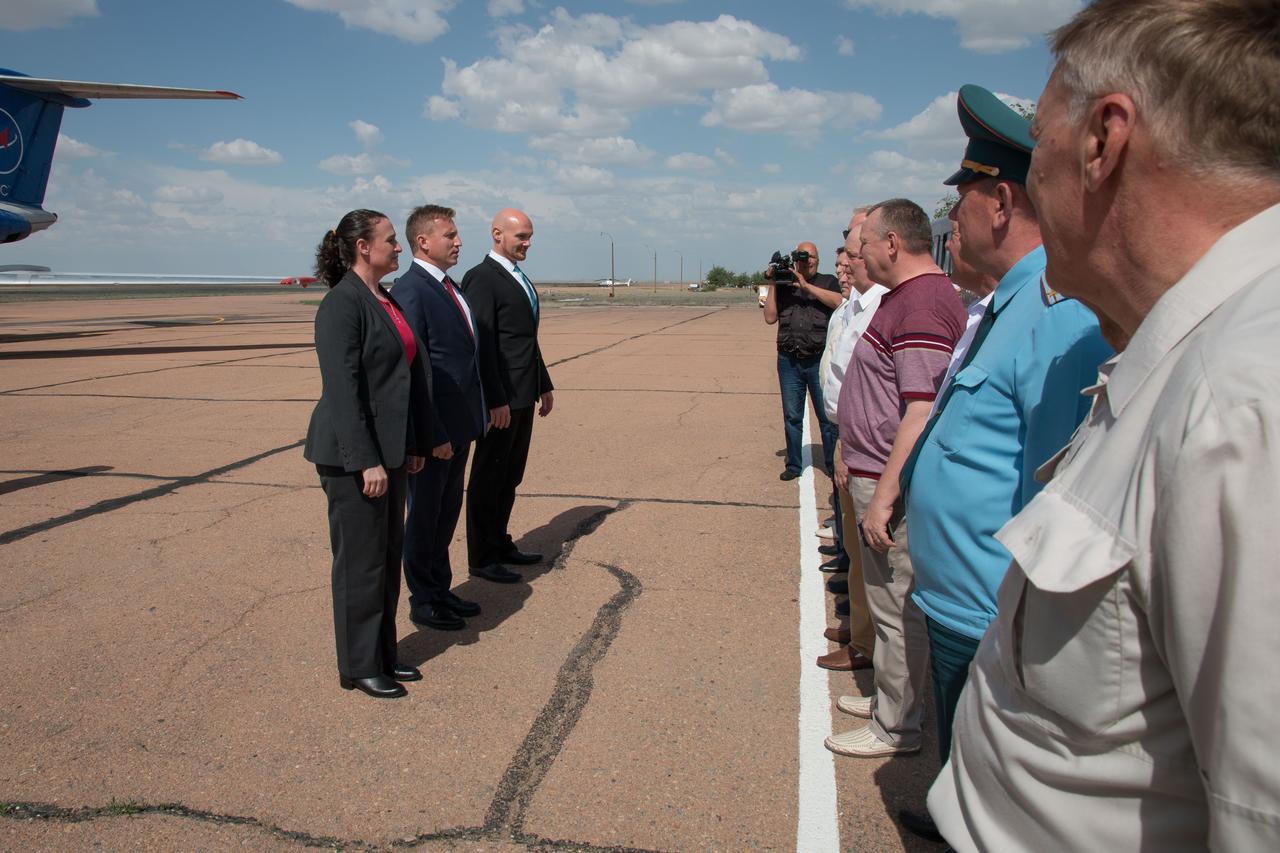 jsc2018e049987 - Expedition 56 crewmembers Serena Aunon-Chancellor of NASA (left), Sergey Prokopyev of Roscosmos (center) and Alexander Gerst of the European Space Agency (right) report to Russian space officials May 19 after arriving at their launch site at the Baikonur Cosmodrome in Kazakhstan May 19 following a flight from their training base in Star City, Russia. They will launch June 6 on the Soyuz MS-09 spacecraft from the Baikonur Cosmodrome for a six-month mission on the International Space Station...NASA/Victor Zelentsov.