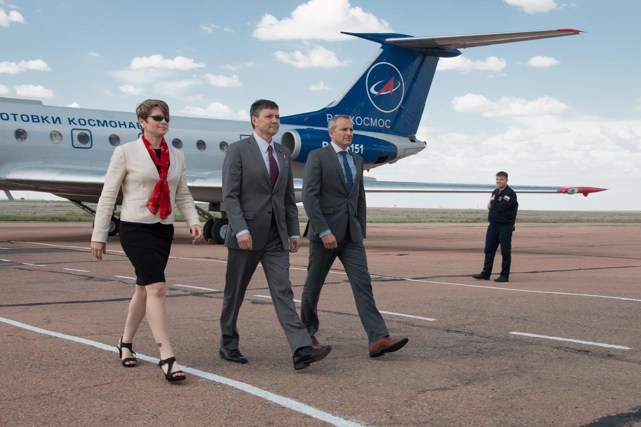 jsc2018e049989 - Expedition 56 backup crewmembers Anne McClain of NASA (left), Oleg Kononenko of Roscosmos (center) and David Saint-Jacques of the Canadian Space Agency arrive at the launch site at the Baikonur Cosmodrome in Kazakhstan May 19 for final training following a flight from their training base in Star City, Russia. They are the backups to Serena Aunon-Chancellor of NASA, Sergey Prokopyev of Roscosmos and Alexander Gerst of the European Space Agency who will launch June 6 on the Soyuz MS-09 spacecraft from the Baikonur Cosmodrome for a six-month mission on the International Space Station...NASA/Victor Zelentsov.