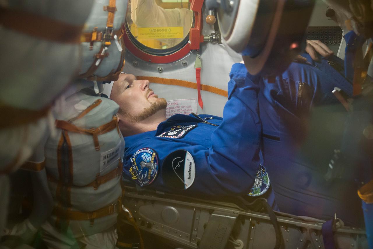 jsc2018e049992 - In the Integration Facility at the Baikonur Cosmodrome in Kazakhstan, Expedition 56 crewmember Alexander Gerst of the European Space Agency runs through procedures May 20 in the Soyuz MS-09 spacecraft as part of the first fit check dress rehearsal activities. Gerst, Serena Aunon-Chancellor of NASA and Sergey Prokopyev of Roscosmos will launch June 6 on the Soyuz MS-09 spacecraft from Baikonur for a six-month mission on the International Space Station...NASA/Victor Zelentsov.