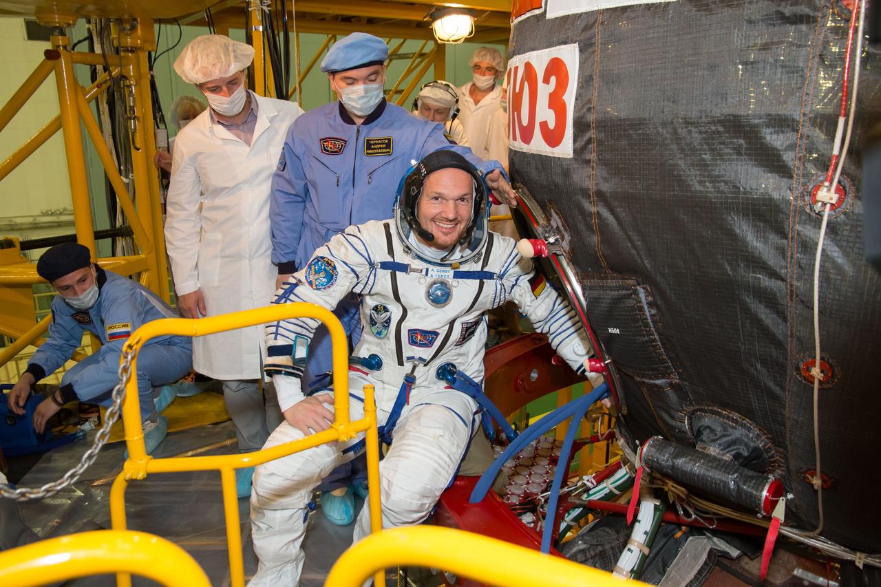 jsc2018e050002  - In the Integration Facility at the Baikonur Cosmodrome in Kazakhstan, Expedition 56 crewmember Alexander Gerst of the European Space Agency poses for pictures May 20 as he prepares to board the Soyuz MS-09 spacecraft for the first fit check dress rehearsal activities. Gerst, Serena Aunon-Chancellor of NASA and Sergey Prokopyev of Roscosmos will launch June 6 on the Soyuz MS-09 spacecraft from Baikonur for a six-month mission on the International Space Station...NASA/Victor Zelentsov.
